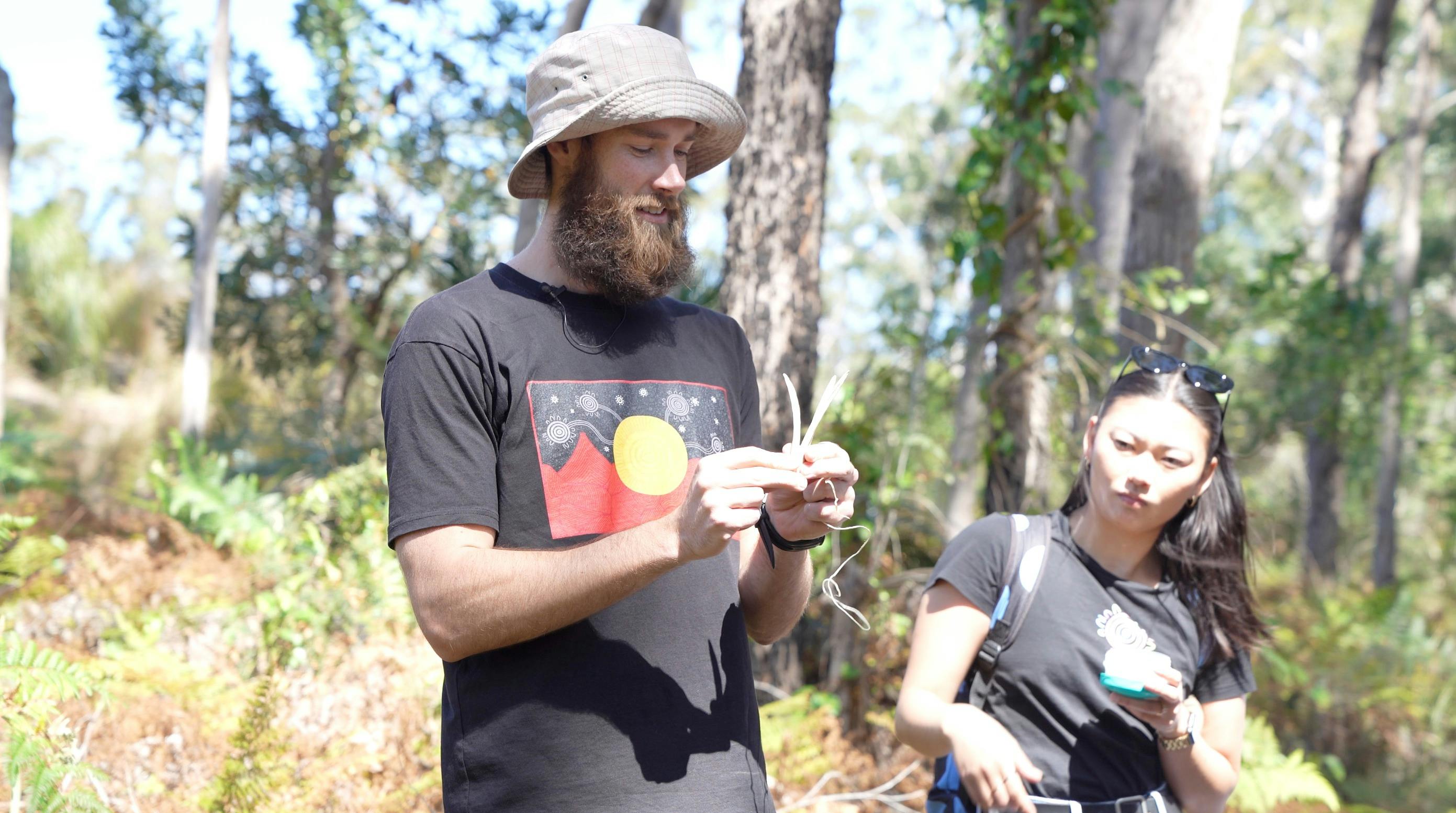 Felix showing kangaroo bones for traditional fishing spearhead