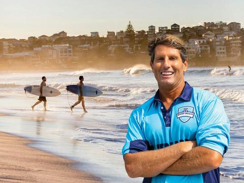 Anthony "Harries" Caroll in front of surfers on Bondi Beach