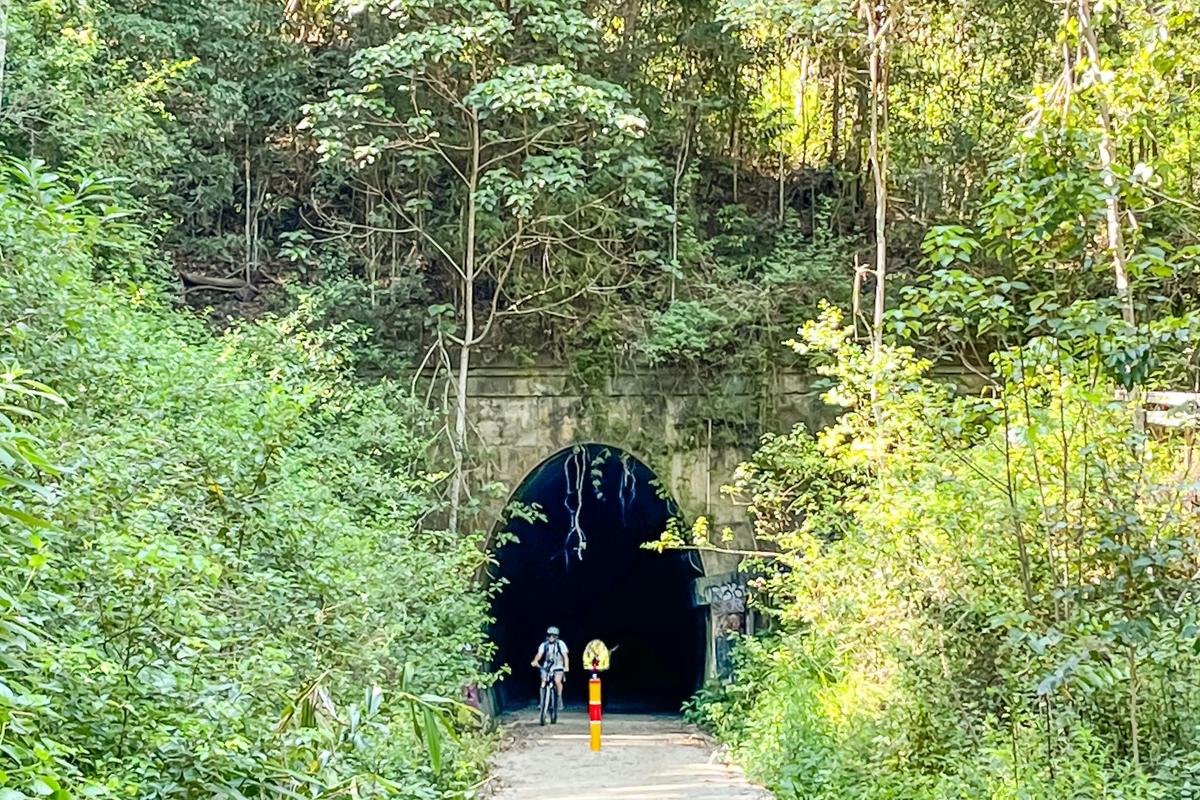 The 524m long Burringbar Tunnel on the Northern Rivers Rail Trail with E Biker approaching.