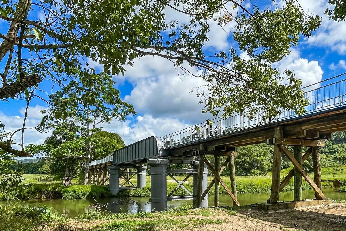 E Bike riders crossing the historic Mills Creek bridge on the Northern Rivers Rail Trail