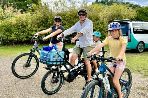 Family on E Bikes with kids e bike and cargo bike ready to depart