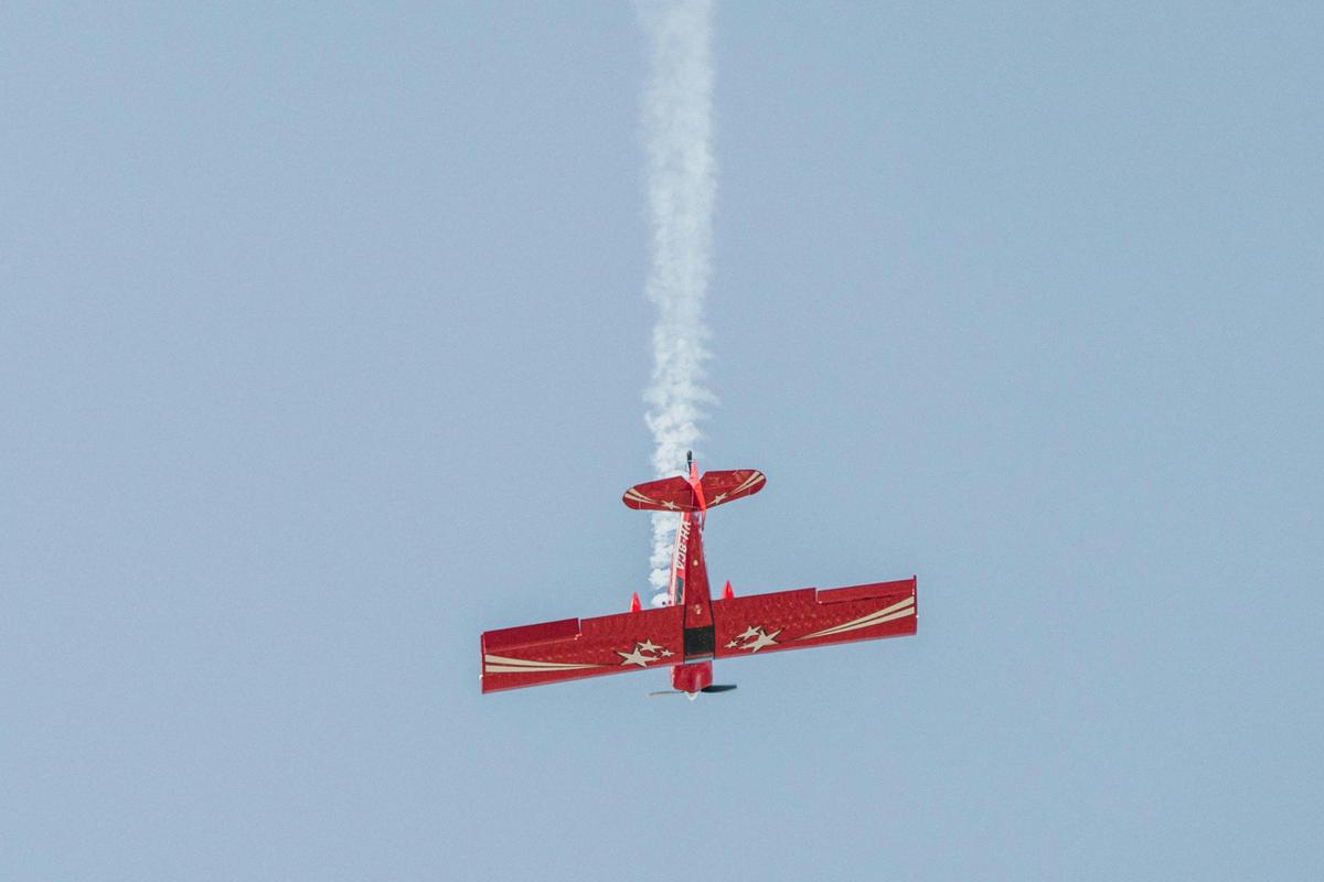 Pilot demonstrating an aerobatic move with smoke