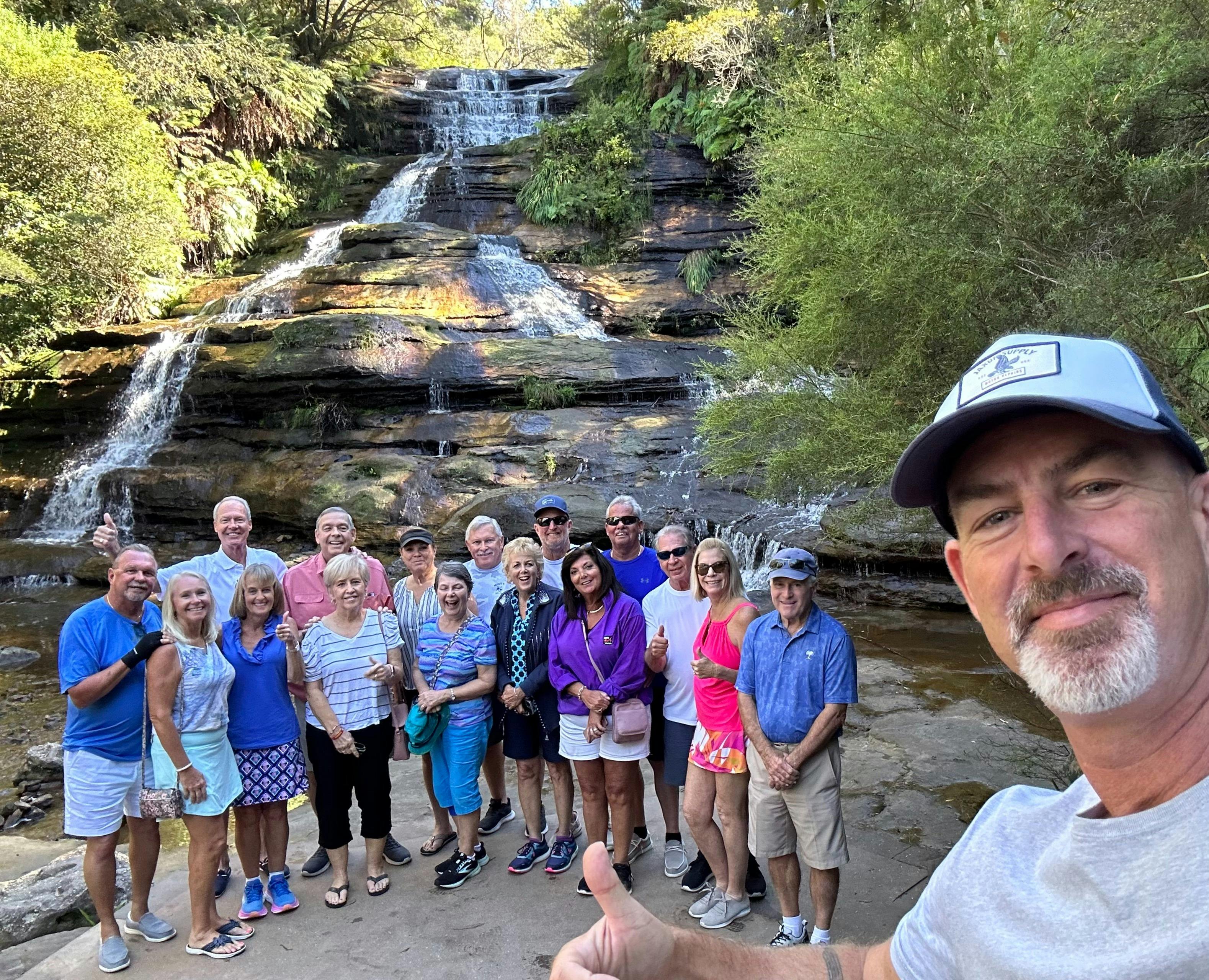 Tour guide Sean with a tour group at a hidden waterfall in the Mountains