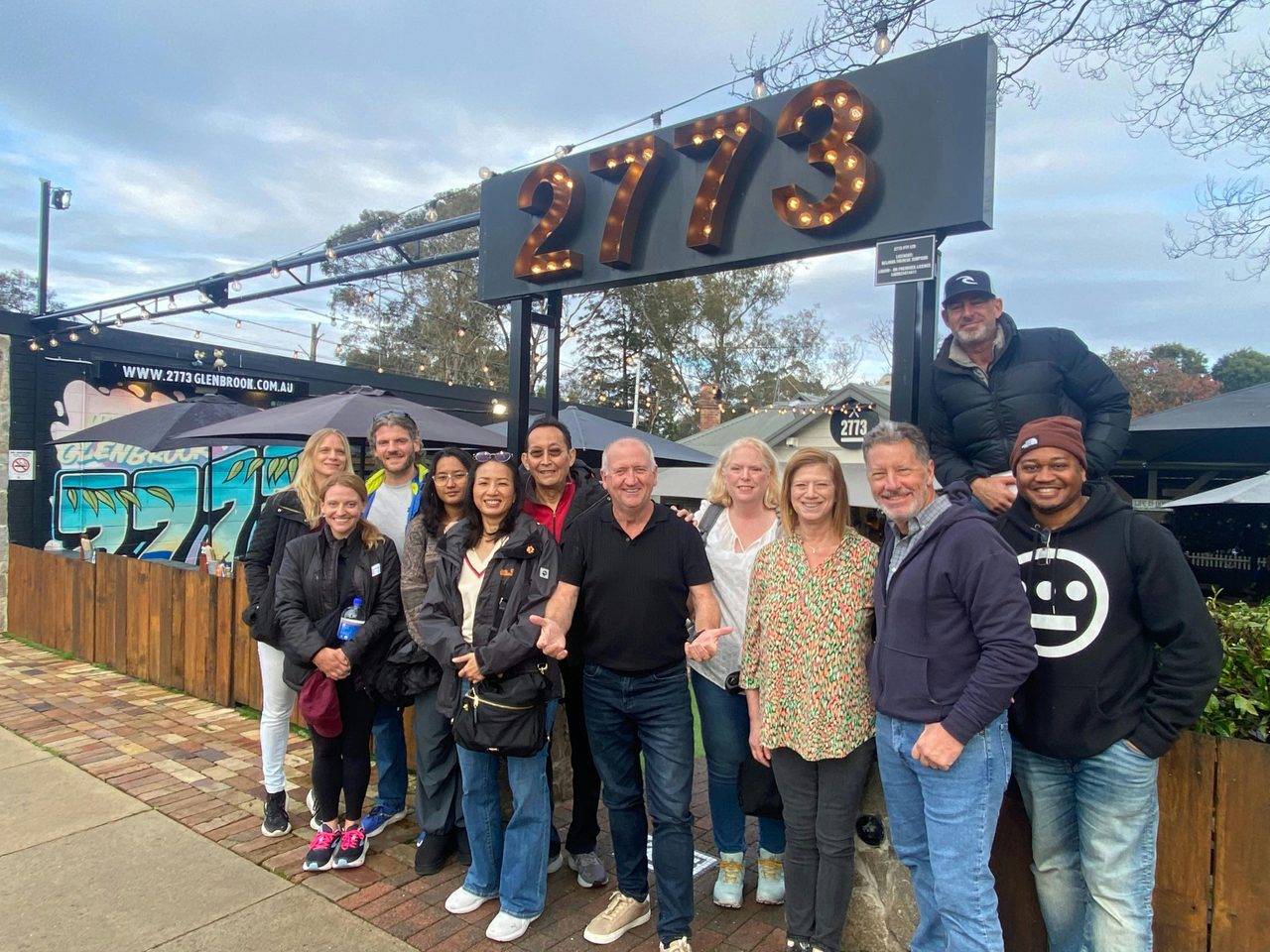 Chapo poses with guests outside one of our restaurant partners after a classic Aussie breakfast