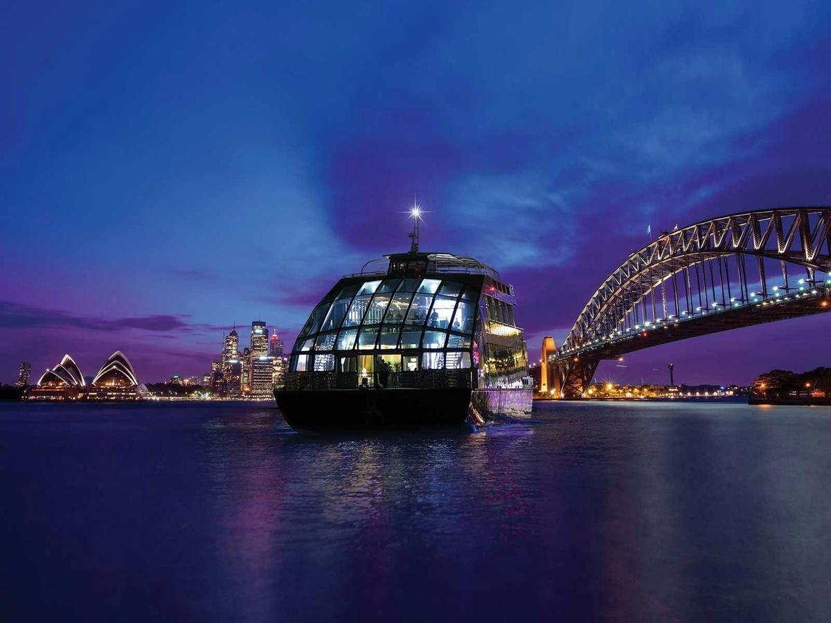 Clearview Glass Boat cruising Sydney Harbour near Opera House and Harbour Bridge at night