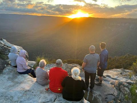 Travellers sittings at Lincons Rock at Sunset overlooking the Jamison Valley