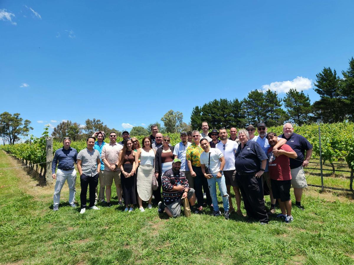 A diverse group of individuals standing together in a vast field, showcasing unity and togetherness.