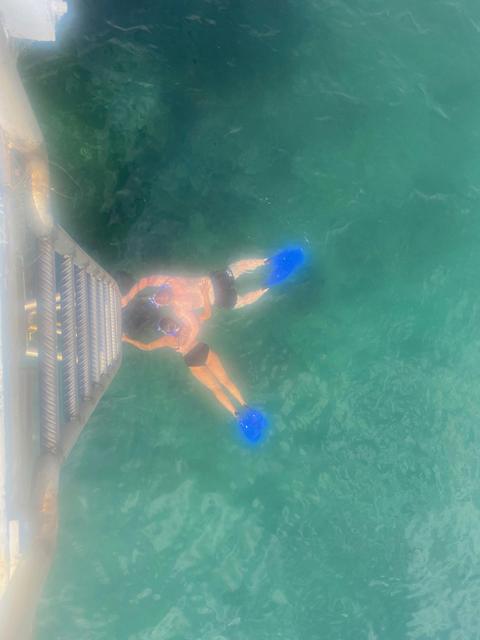Aerial view of two people snorkeling in clear blue water