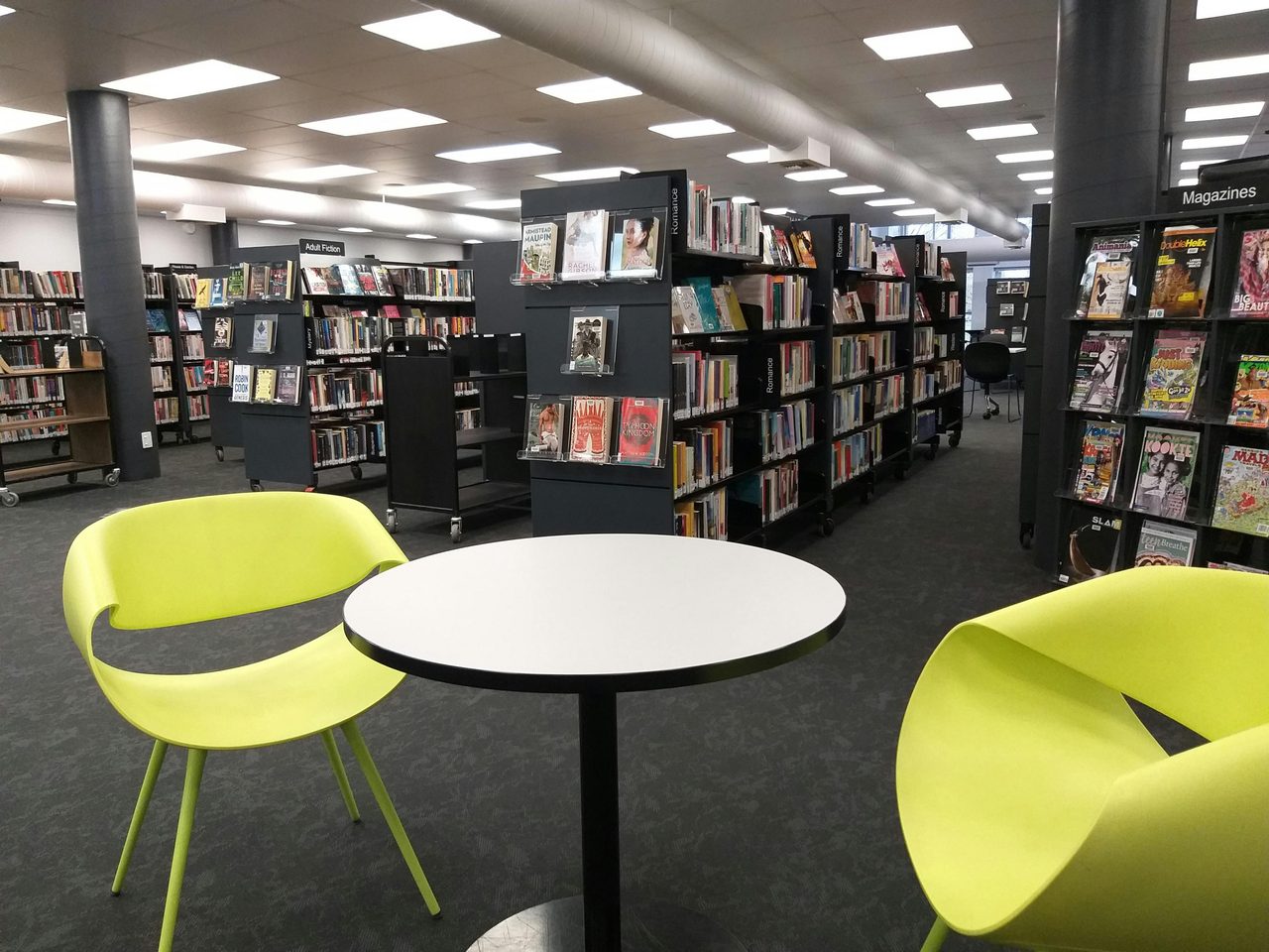 Two green chairs in library