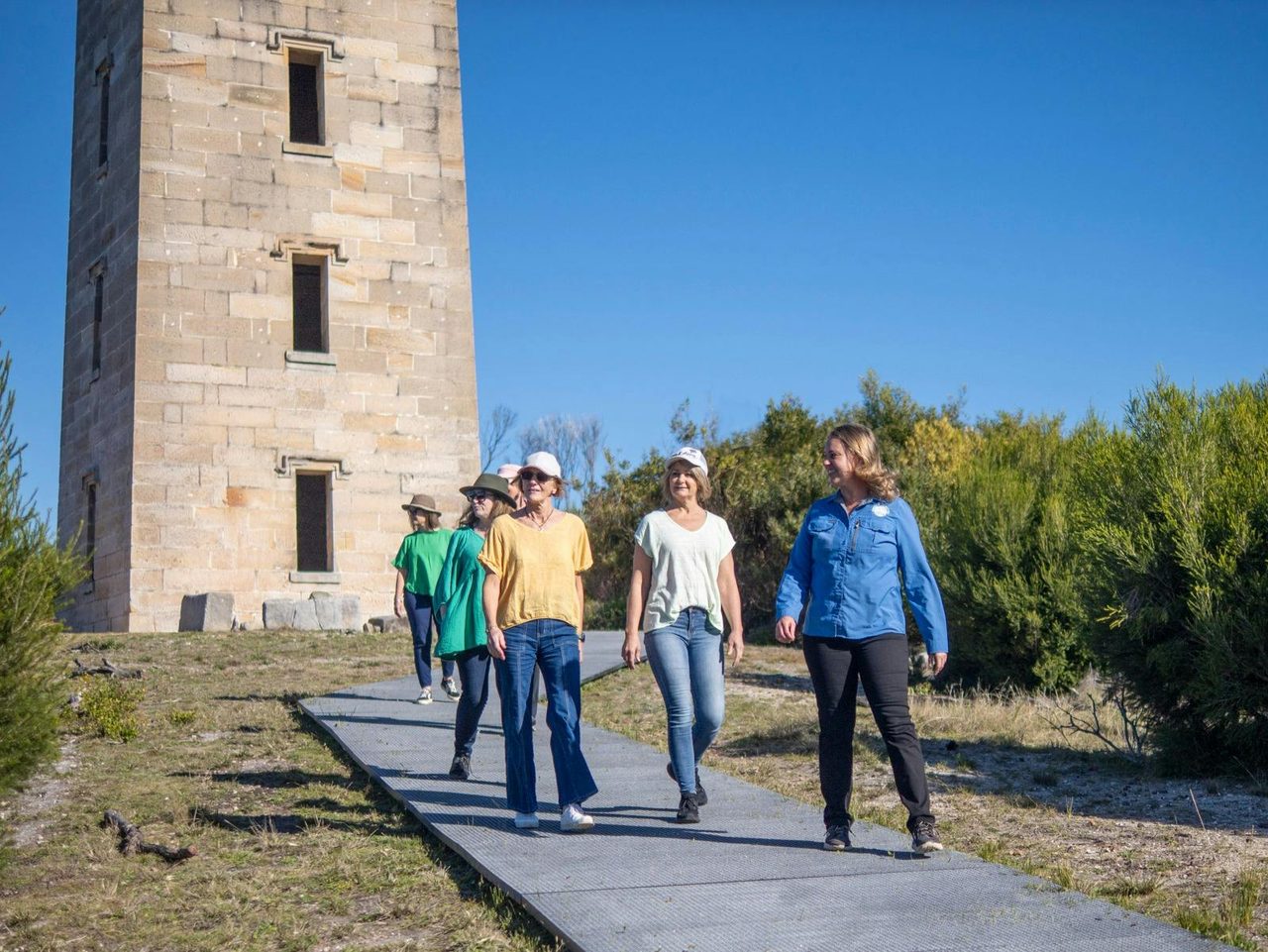 Guests walking in front of the impressive Boyds Tower, led by their knowledgeable guide .
