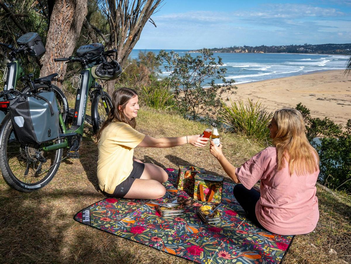 Guests enjoy a picnic lunch on their self-guided e-bike tour Tathra