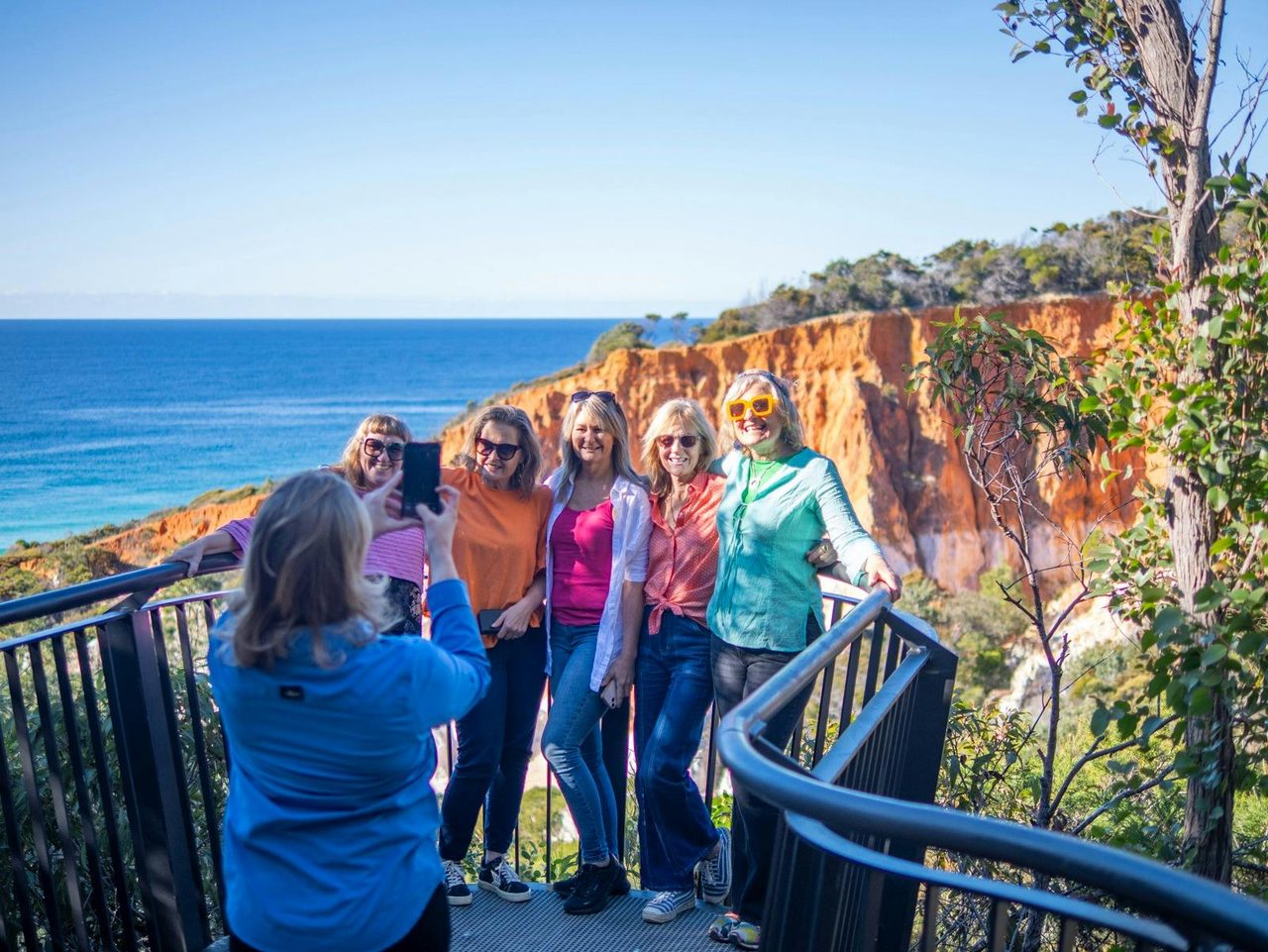 Guide taking photos of guests enjoying the iconic Pinnacles near Eden, NSW.