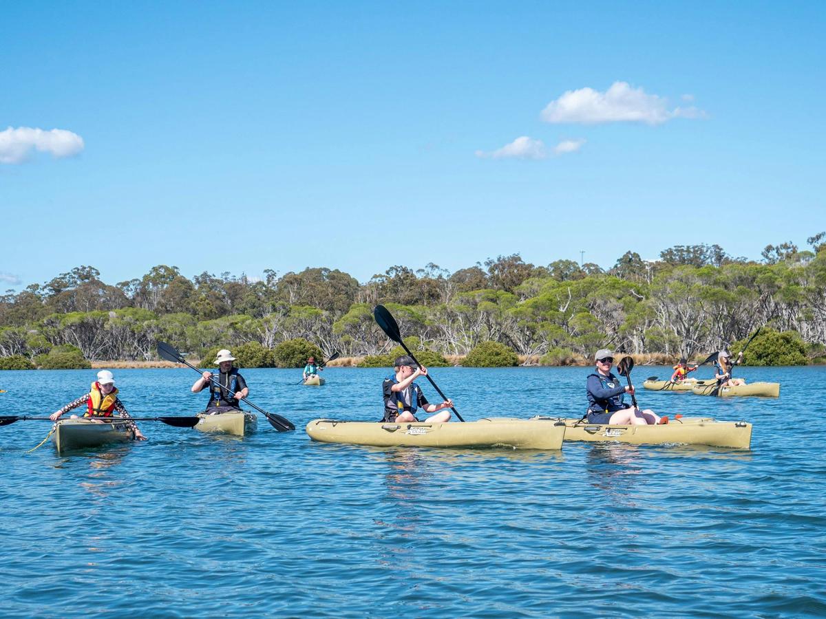Guests kayaking Pambula Lake