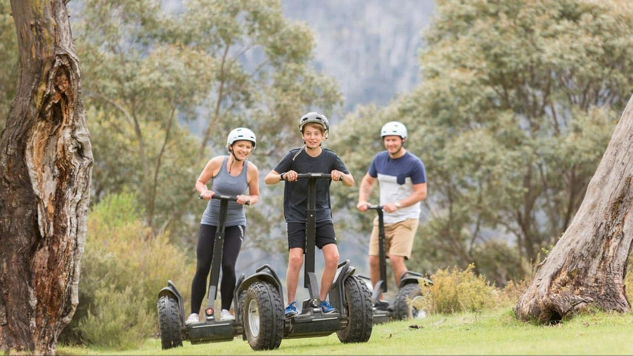 Three people riding electric segways