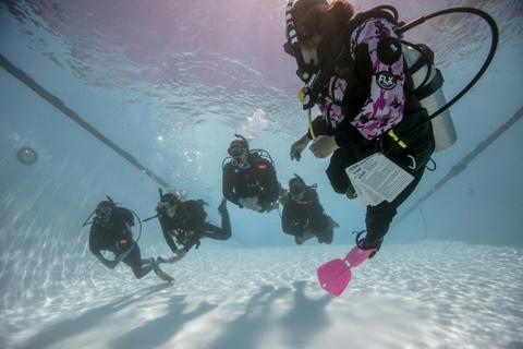 Students in a confined water setting with instructor