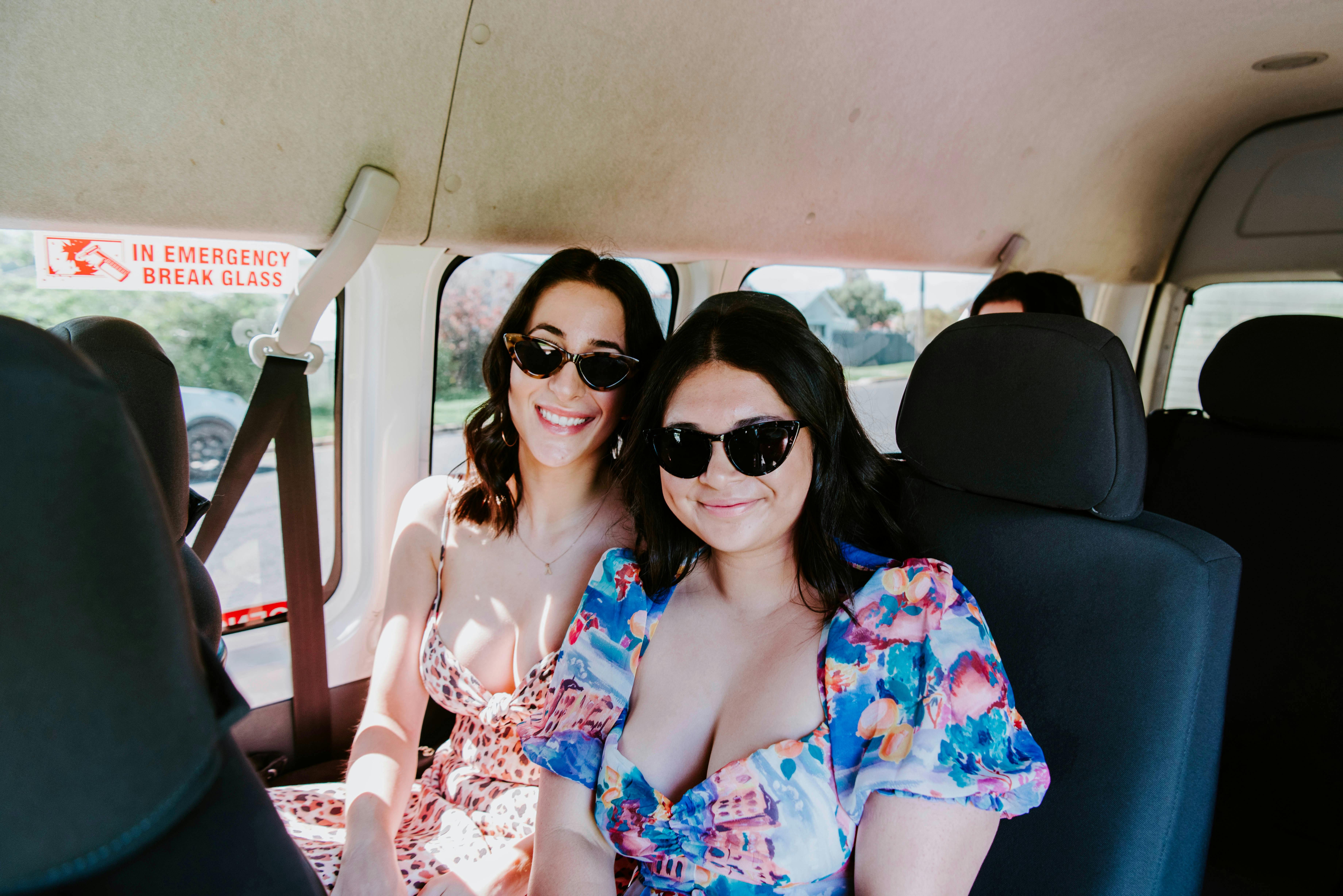 Two girls sitting inside tour bus
