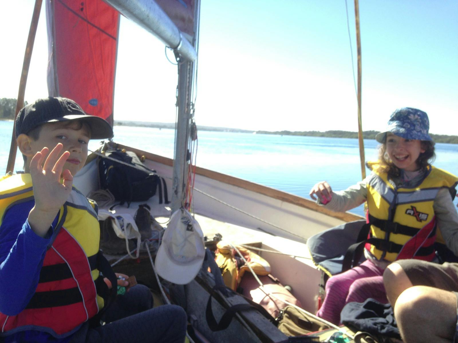 Happy chidren enjoying a day out on the river with Dad