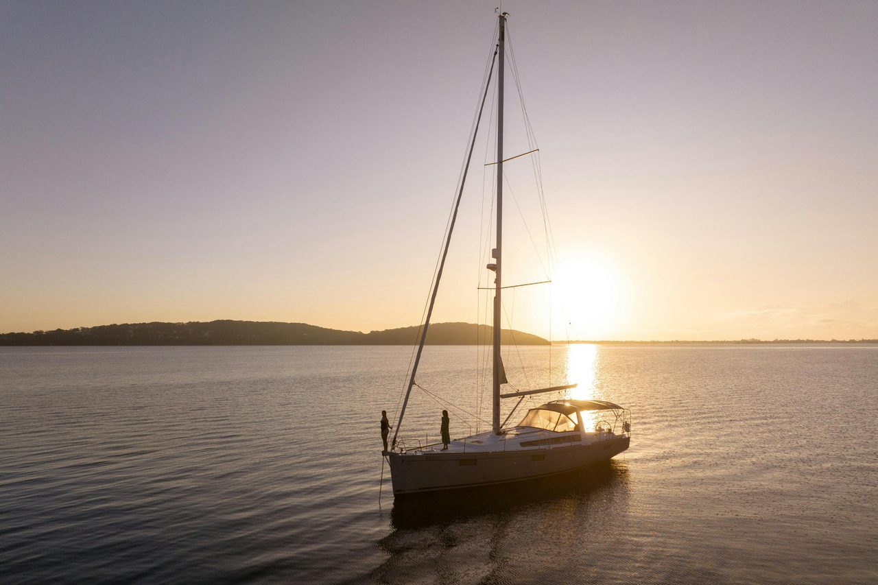 Standing on the bow with Sail Lake Macquarie, with the sun in the background