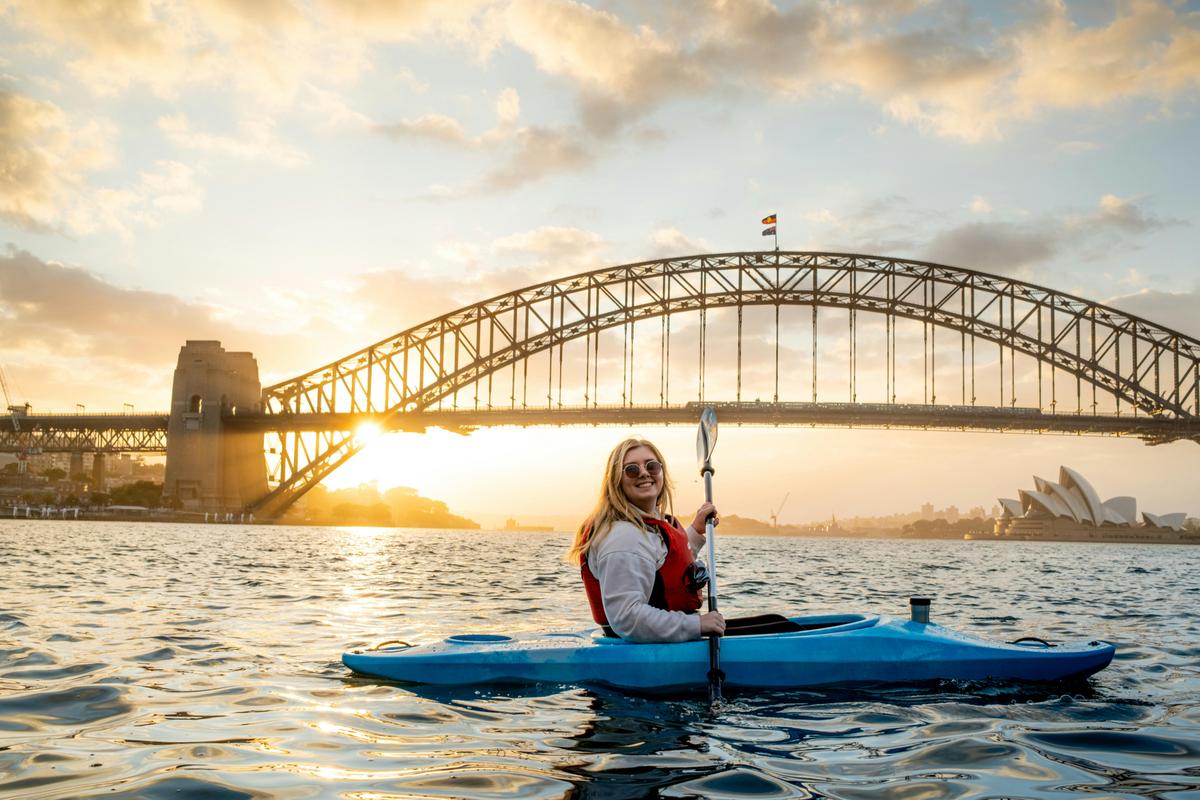 Sunrise Kayak and Coffee on Sydney Harbour with Sydney Harbour Bridge and Opera House illuminating.
