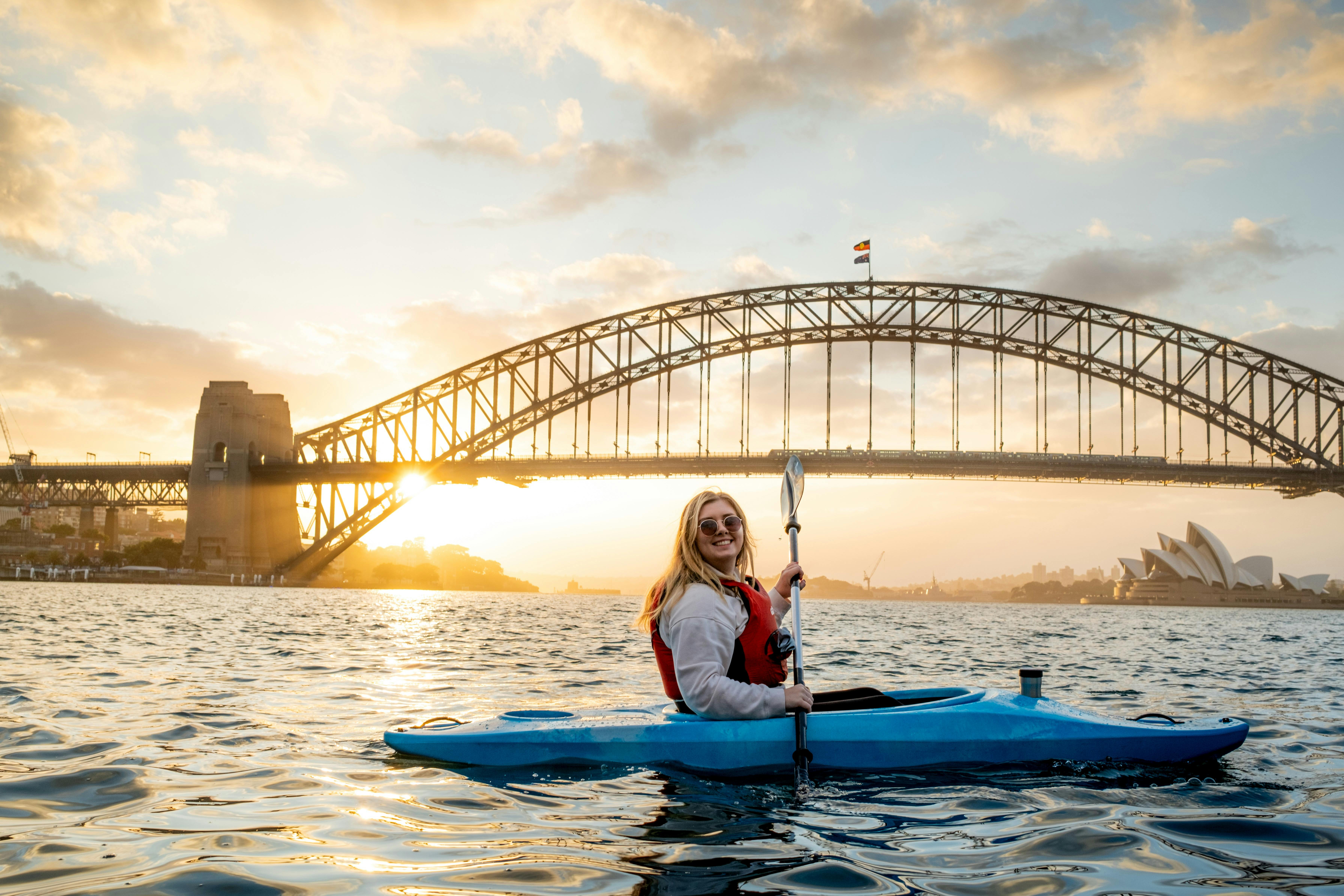Sunrise Kayak and Coffee on Sydney Harbour with Sydney Harbour Bridge and Opera House illuminating.