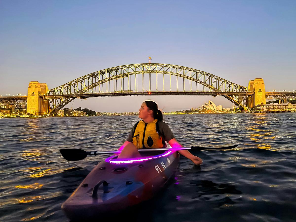 Witness Sydney Harbour Bridge and Opera House glow at sunset from your pink-led-lit kayak.