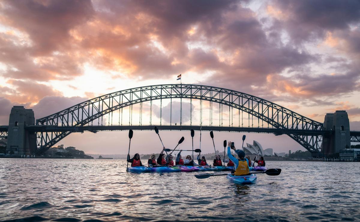 Laura Stone taking the perfect photo of kayakers on Sydney Harbour