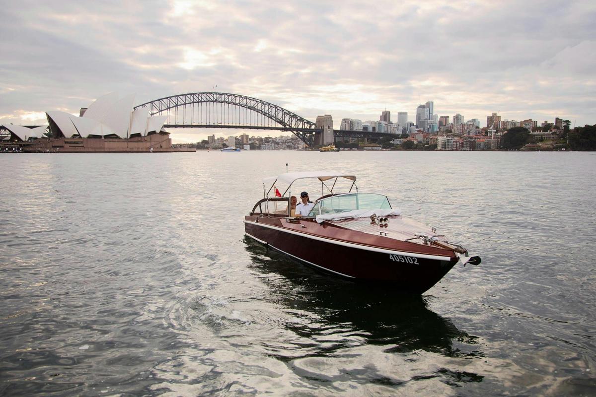 MV BEL private cruise on Sydney Harbour with Sydney city skyline and Harbour Bridge.