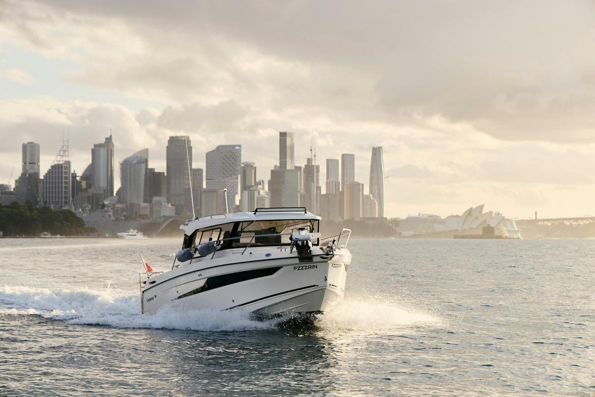 MV Explorer luxury cruise boat on Sydney Harbour with Harbour Bridge in the background.