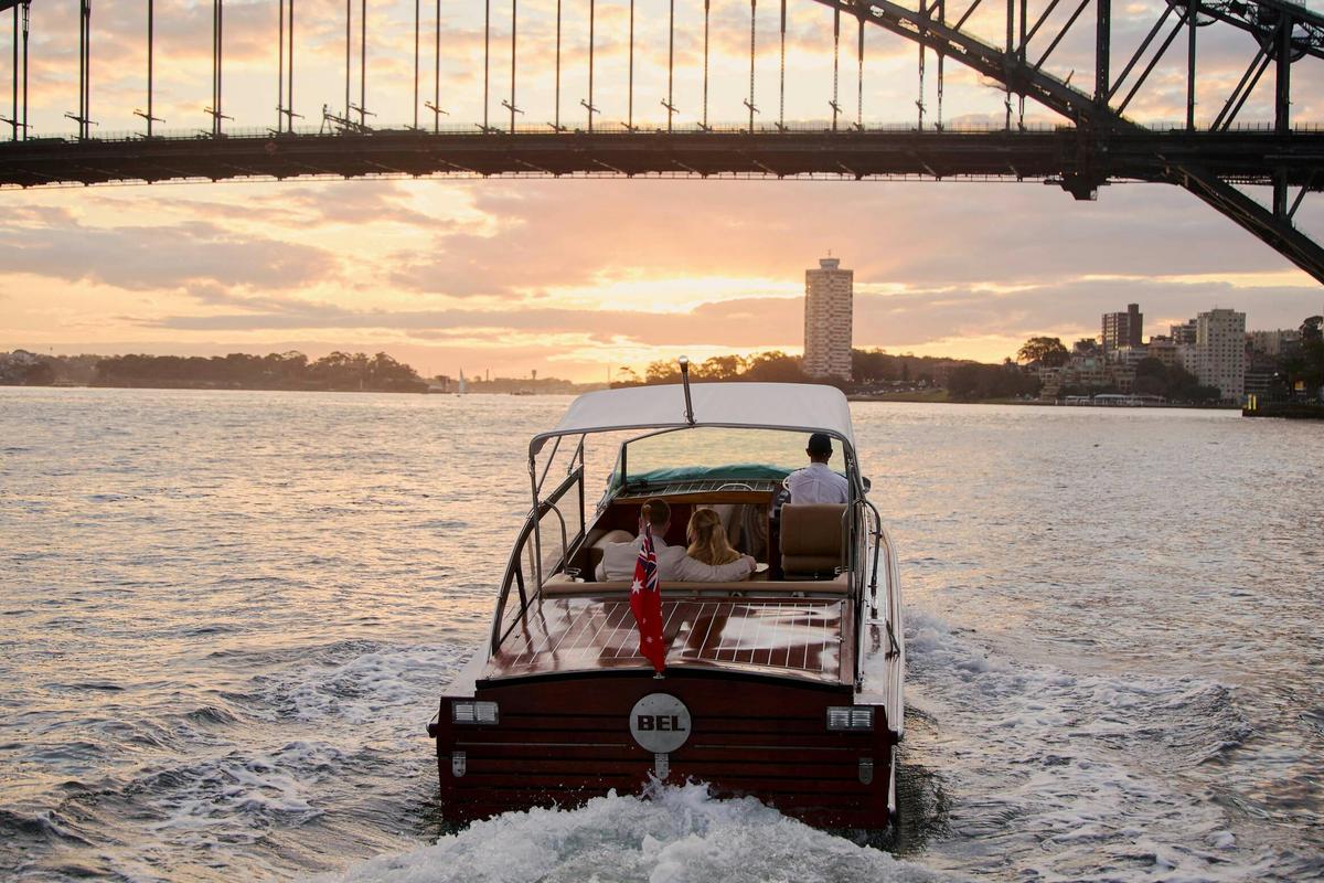 MV BEL private cruise on Sydney Harbour with Sydney city skyline and Harbour Bridge.