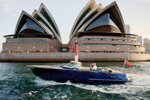 Private boat tour on MV Aquamajestic cruising Sydney Harbour with city skyline views.