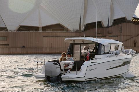 MV Explorer luxury cruise boat on Sydney Harbour with Harbour Bridge in the background.