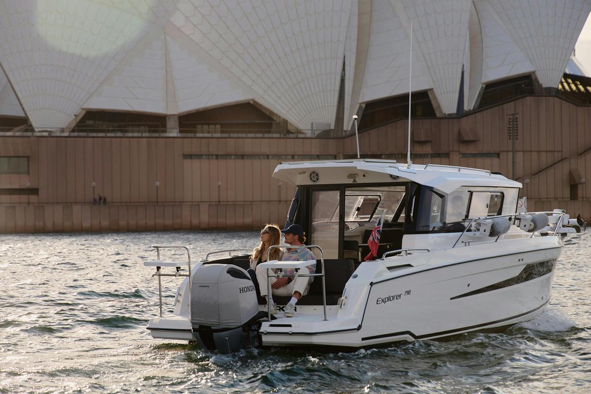 MV Explorer luxury cruise boat on Sydney Harbour with Harbour Bridge in the background.