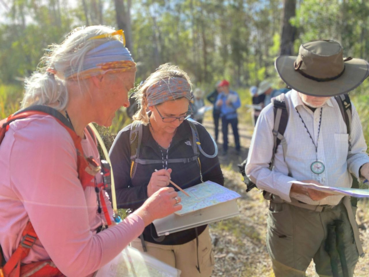 Instructor Caro Ryan assists students with learning to read a topographic map