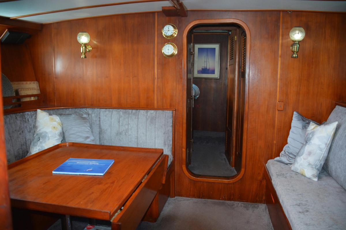 The saloon area aboard Sydney Sundancer enriched with teak which has been all hand crafted.
