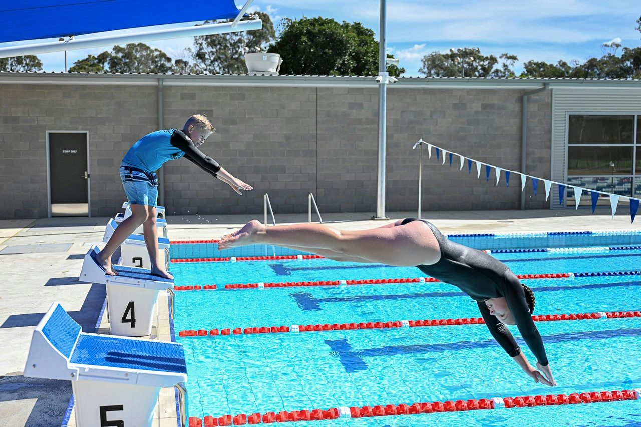 50m pool children diving from blocks
