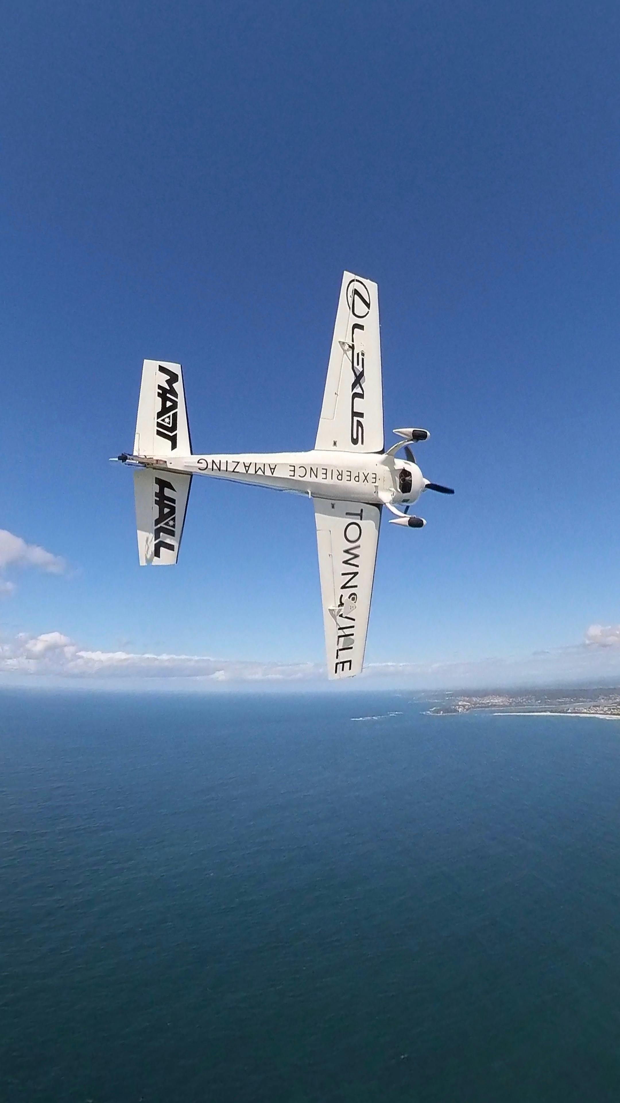 Matt Hall Racing Extra 300 overhead Redhead beach, in formation near Lake Macquarie Airport NSW
