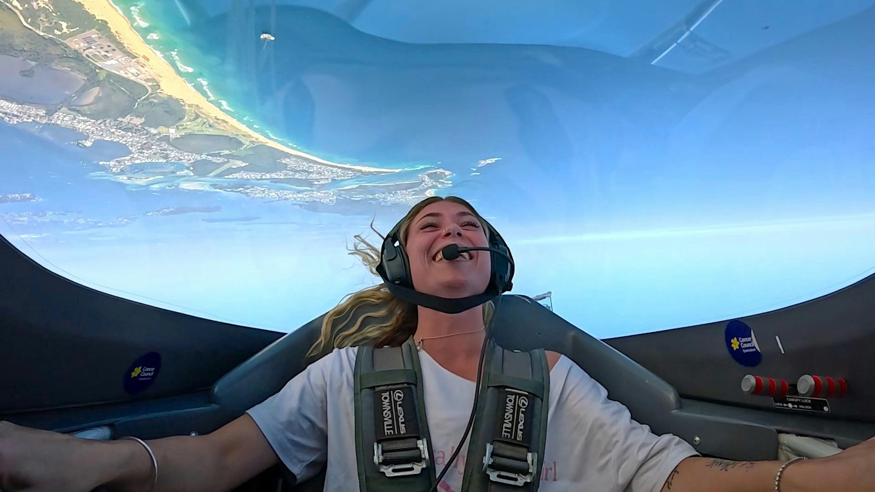 Aerobatic joy flight passenger having the ride of their life overhead Redhead beach, Lake Macquarie