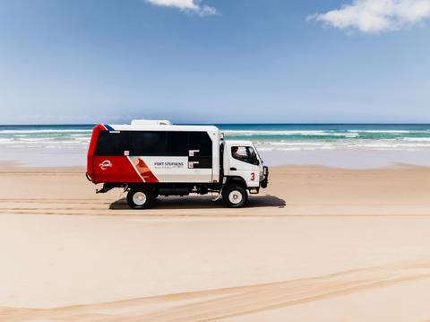 4WD Vehicle driving along beach