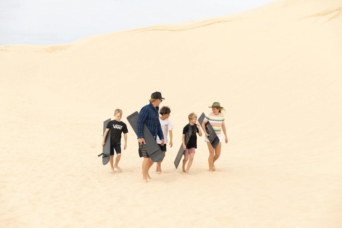 Family getting ready to sandboard