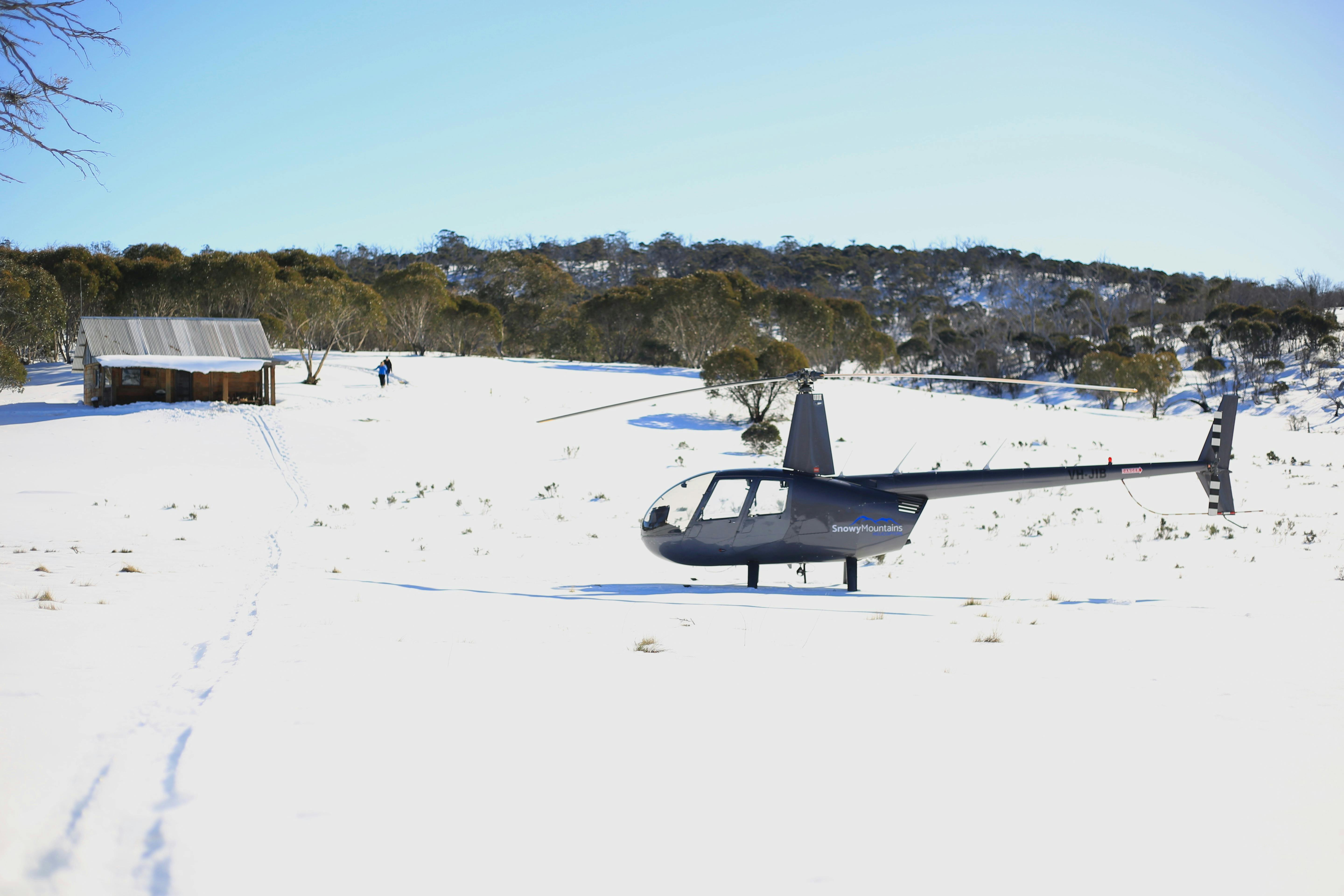 Robinson R44 landed on snow at private hut for Wilderness Picnic