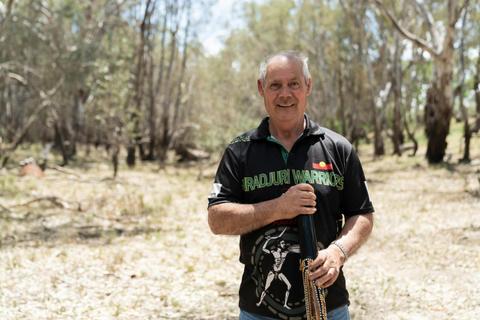 Wiradjuri man standing in River Red Gum bushland