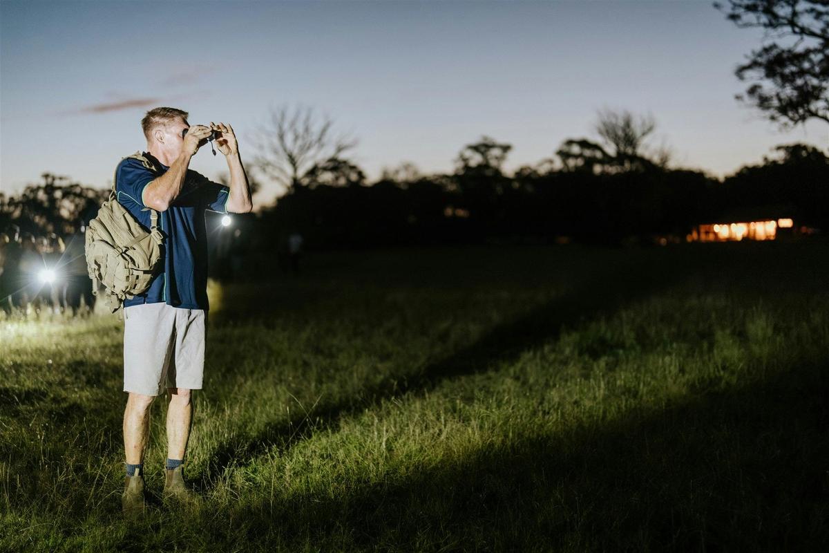 Our guide using the thermal night vision monocular to spot native animals at night  in our paddocks