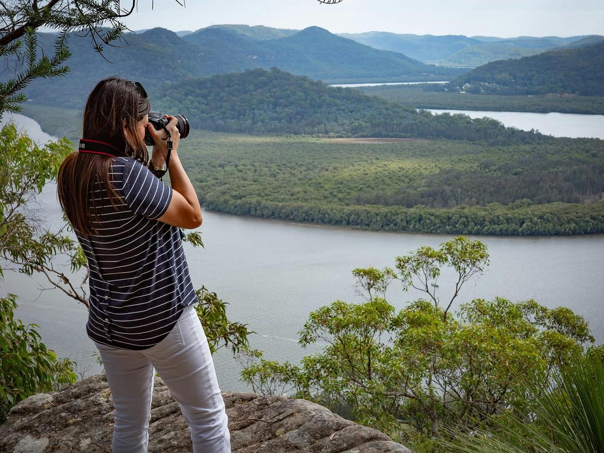 Photographing vast wilderness beyond the city skyline.