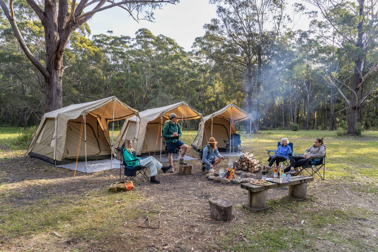 Walkers relaxing at the end of the day around the fire at camp.