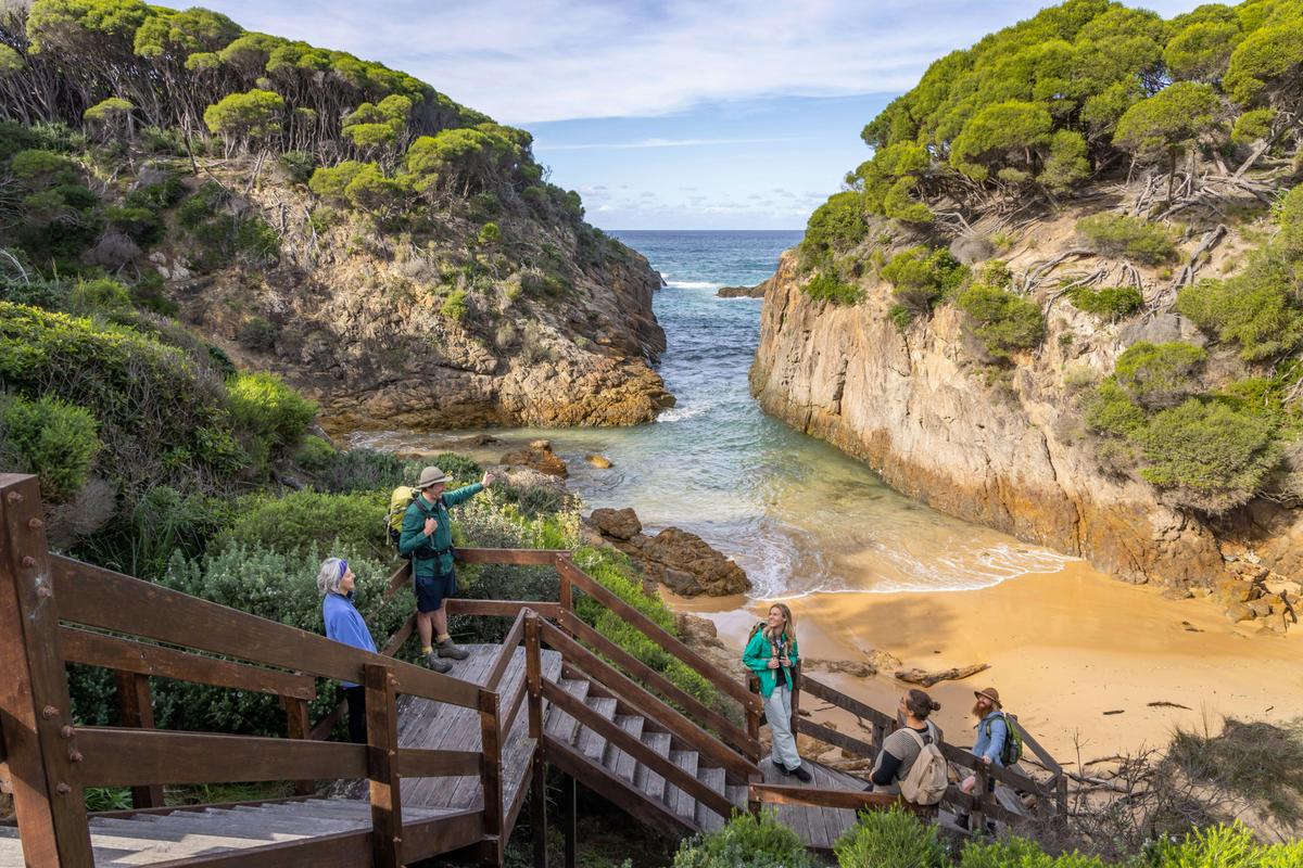 Walkers enjoying the views at Wallagoot Lake in Bournda National Park on the Wharf to Wharf walk