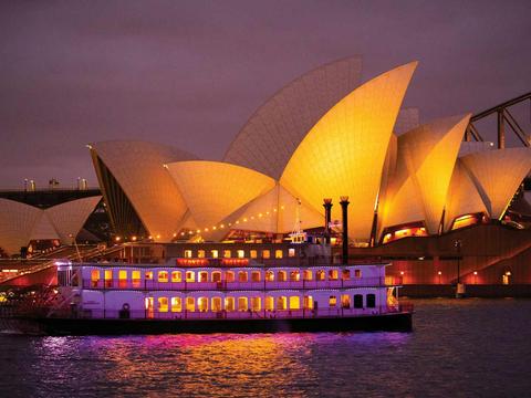 Showboat cruising past Opera House