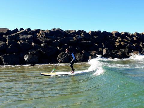 SUP Surfer Anthony riding at wave at Little Lake Barrack Point