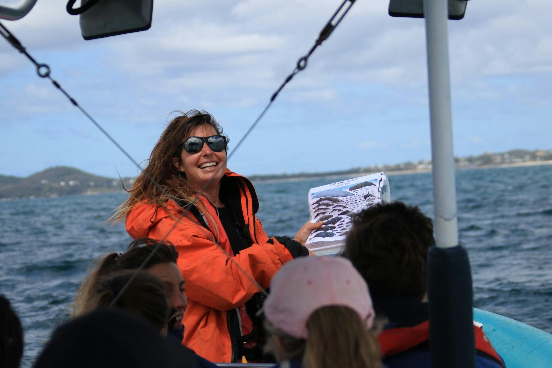 whale watching boat tour guide doing a presentation