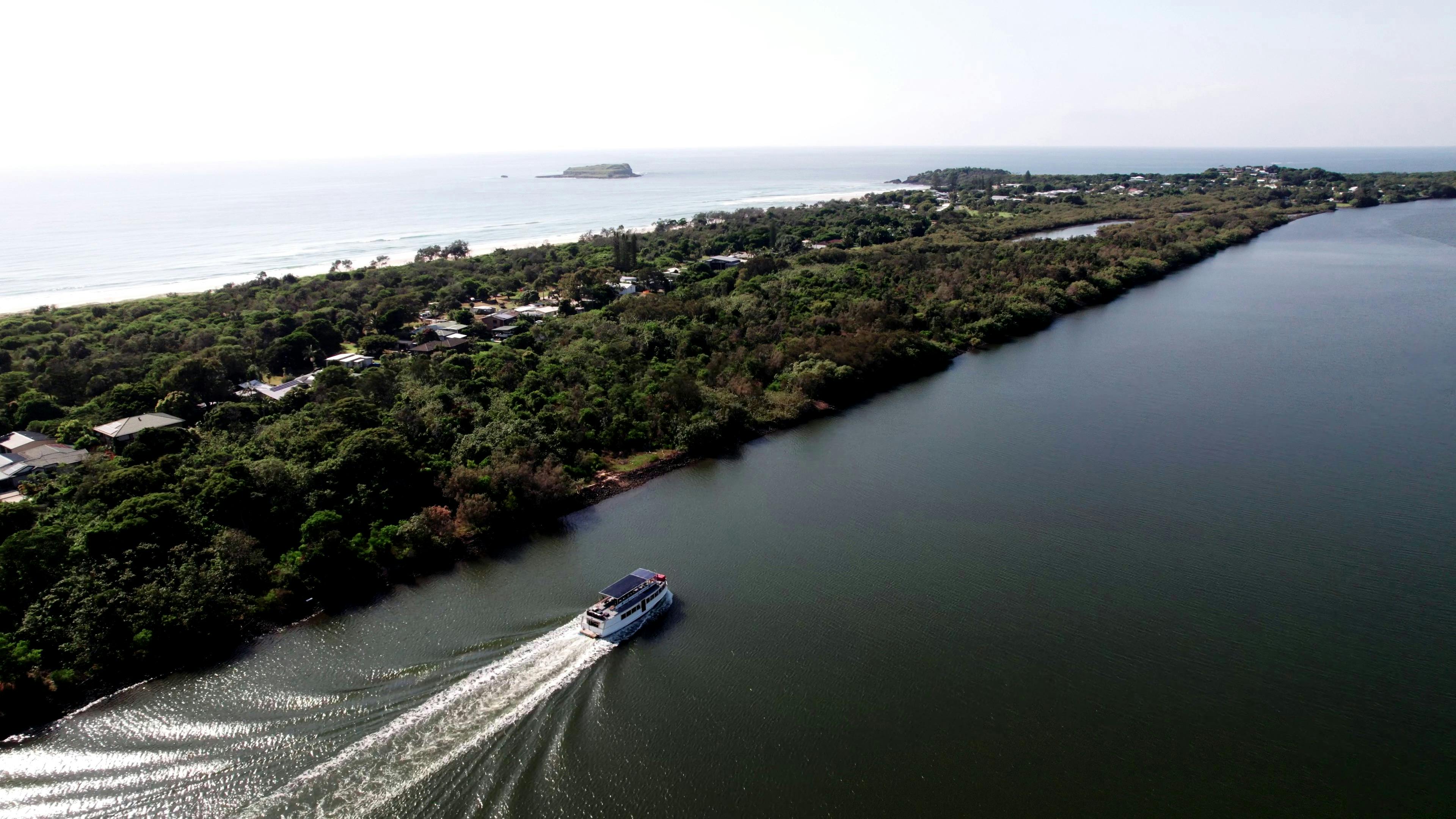 Golden Swan cruising past Fingal on the Tweed River