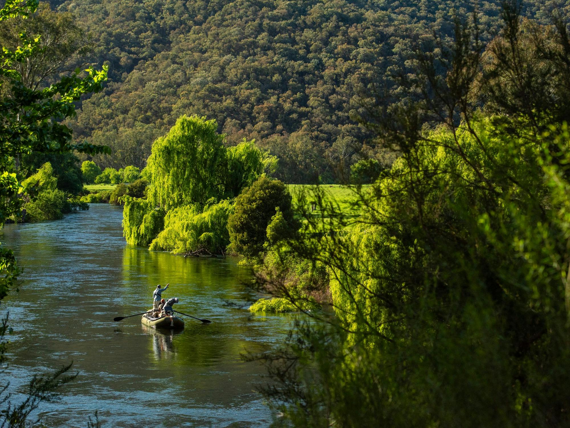 Drifting down the Tumut River fly fishing for trout.